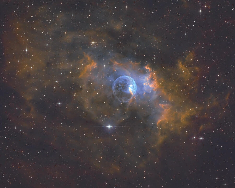 The Bubble Nebula photographed in the sulfur, hydrogen, and oxygen Hubble palette.